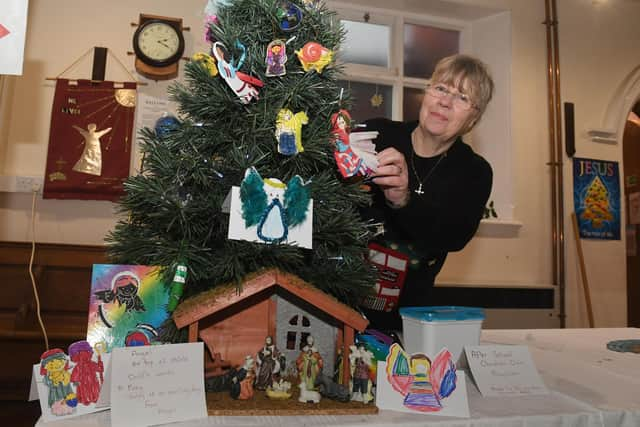 Susan Alldread of Wainfleet decorating a children's tree.