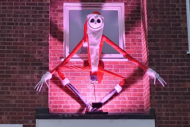 Danny Dowding's hand-made Jack Skellington hovers over the front door of his house.