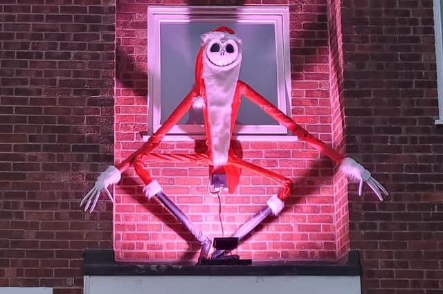 Danny Dowding's hand-made Jack Skellington hovers over the front door of his house.