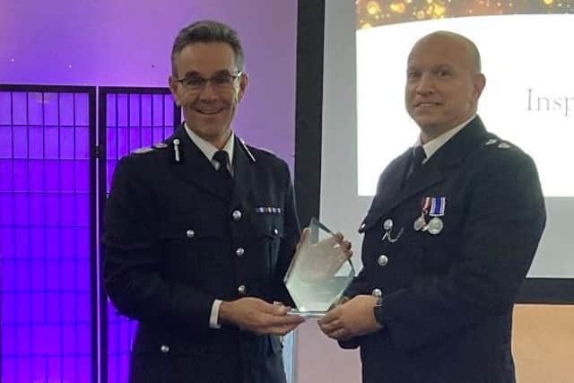 Insp Colin Haigh receives his award from Chief Constable Chris Hayward.