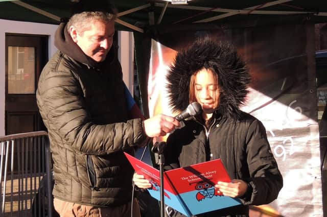 William Alvey School headteacher Stephen Tapley with one of his pupils doing festive poems in the market place. EMN-210612-152222001