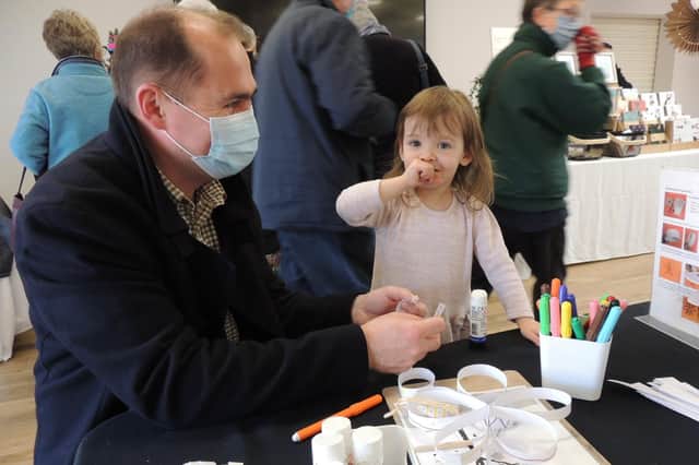 Jozef Slezak and two year old daughter Daniela Slezakova of Sleaford join in the children's crafts on offer at The Hub. EMN-210612-152505001