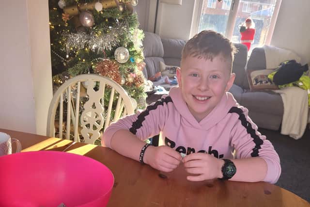 Ethan with all the raffle tickets sold, doing the prize draw. EMN-210912-095703001