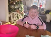 Ethan with all the raffle tickets sold, doing the prize draw. EMN-210912-095703001