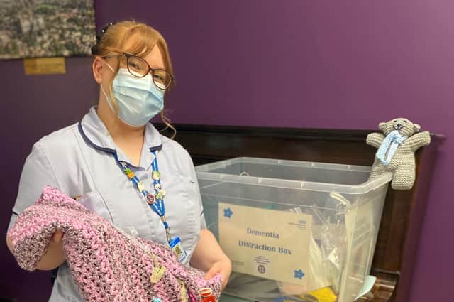 Dementia practitioner Sophie Brown, with one of the boxes at Lincoln hospital.