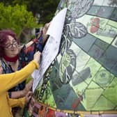A child takes a paper etching of one of the Boston buoys during their launch event. Photo: Electric Egg.