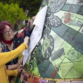 A child takes a paper etching of one of the Boston buoys during their launch event. Photo: Electric Egg.