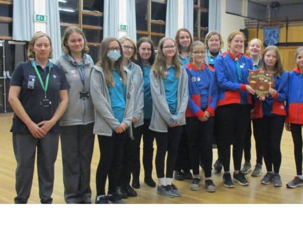 Guides and Rangers of the 4th Sleaford Company with Sir Bob Russell and the historic shield which he bought.