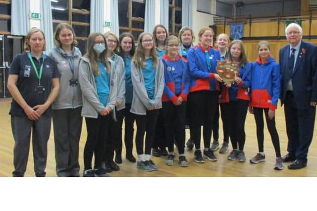 Guides and Rangers of the 4th Sleaford Company with Sir Bob Russell and the historic shield which he bought.
