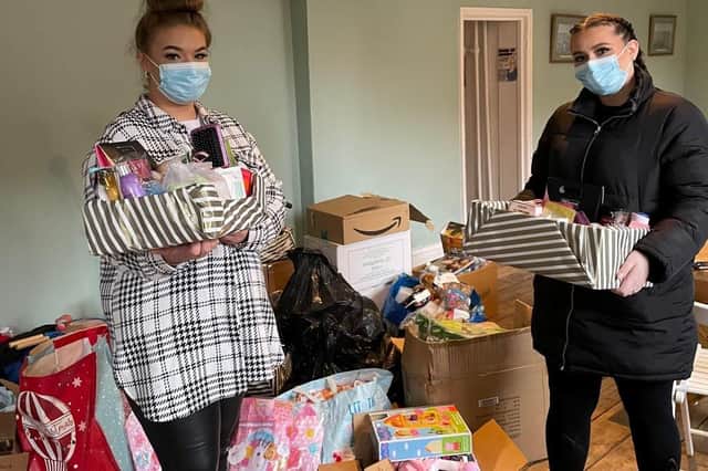 Jasmine Davis (left) Mercedes Hyatt with gifts for women's refuges in Lincolnshire.