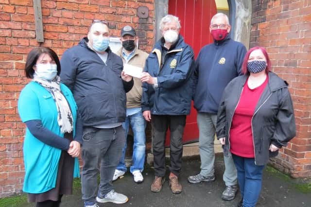 Rotarians Jo Bowman and Malcolm Simpson with Brian Milne and some of the food bank’s army of volunteers