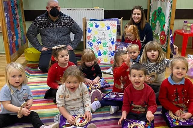 Children at Rauceby Pre-School are thrilled to get their Christmas gifts. EMN-211214-164849001