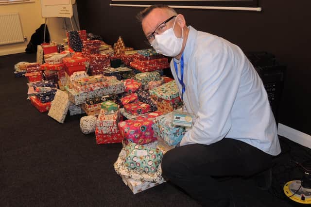 Rod Munro at the New Life Comunity Larder with some of the gifts wrapped that will be given out to individuals and families in need this Christmas. EMN-211220-111558001