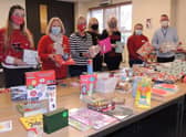 Rod Munro and volunteers from Utility Aid and Lincolnshire Coop wrapping gifts to be handed out to cheer up some of the people the Community Larder supports at Christmas. EMN-211220-173029001