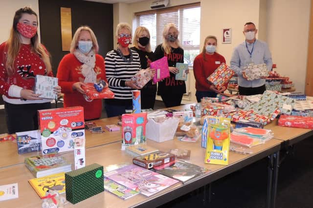 Rod Munro and volunteers from Utility Aid and Lincolnshire Coop wrapping gifts to be handed out to cheer up some of the people the Community Larder supports at Christmas. EMN-211220-173029001