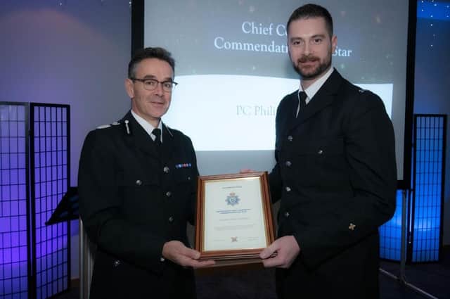 PC Philip McAllister accepts his award from chief constable Chris Haward.