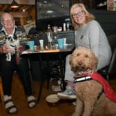 All of those pigs in blankets were heaven for these pooches. Roy Lawson with his dog, Tommy, and Teresa Woodland with her dog, Monty, enjoying the feast.