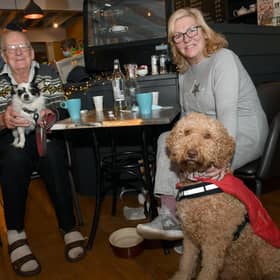 All of those pigs in blankets were heaven for these pooches. Roy Lawson with his dog, Tommy, and Teresa Woodland with her dog, Monty, enjoying the feast.