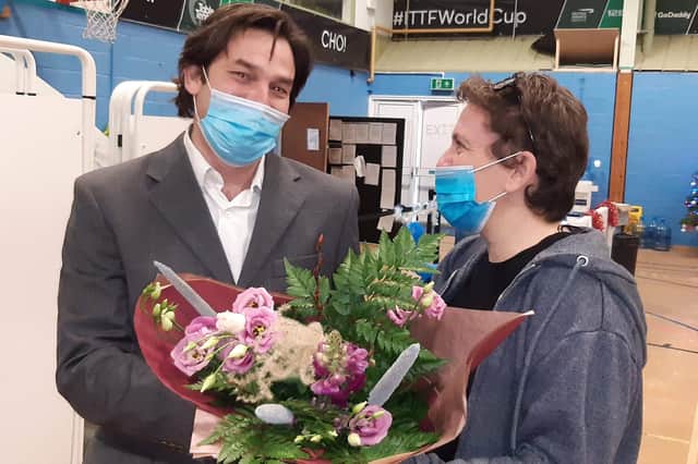 Darren Altus, of K2 Primary Care Group who has coordinated the vaccination programme for Grantham and Sleaford presents a bouquet to the 250,000th patient to get her jab, Andrea Odam of Sleaford. EMN-211217-155945001