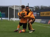 Kyron Gordon helps Jake Wright jnr celebrate his opener in the 4-1 FA Trophy win against Kidderminster Harriers. Photo: Oliver Atkin