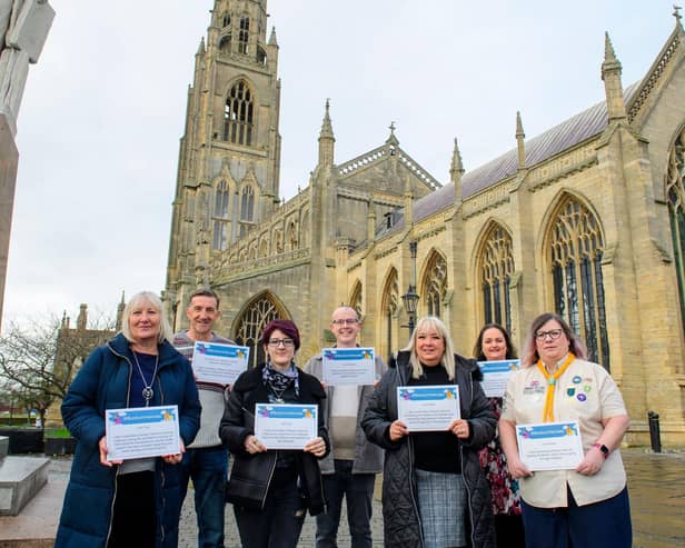 Seven of the winners pose with their certificates outside Boston Stump. Photos: Chris Vaughan Photography.
