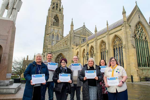 Seven of the winners pose with their certificates outside Boston Stump. Photos: Chris Vaughan Photography.