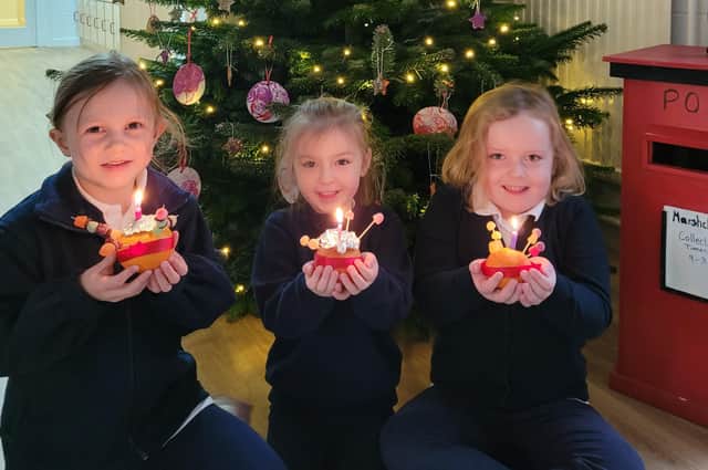 Some of the delighted pupils with their Christingles earlier this month.