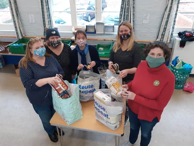 Horncastle Community Larder volunteers packing Christmas food parcels. EMN-211221-093157001