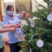 Staff at the Sue Ryder Thorpe Hall Hospice hanging the baubles. EMN-211222-140109001