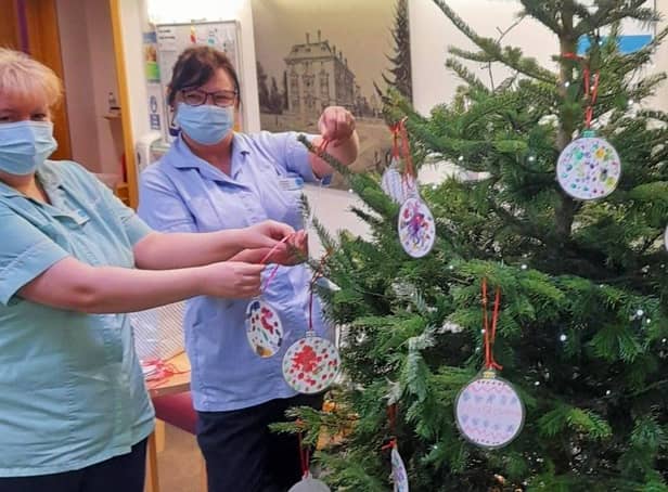 Staff at the Sue Ryder Thorpe Hall Hospice hanging the baubles. EMN-211222-140109001