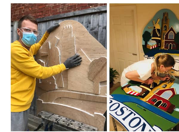 Dmitry and Natalia Buravlev at work on the new town signs for Boston.