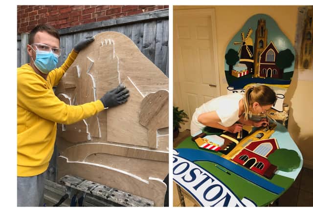 Dmitry and Natalia Buravlev at work on the new town signs for Boston.