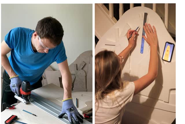 Dmitry and Natalia Buravlev at work on the new town signs for Boston.