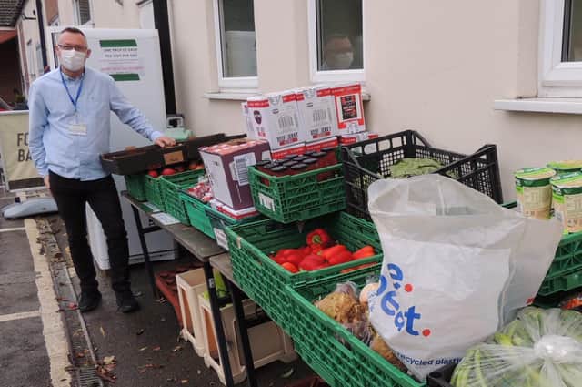 BEM for Team Leader Rod Munro, with the community table stocked with food for the community at Christmas. EMN-211231-133901001