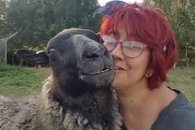 Sheep loving Amanda Gray with Gracie, one of her flock. EMN-220701-154919001