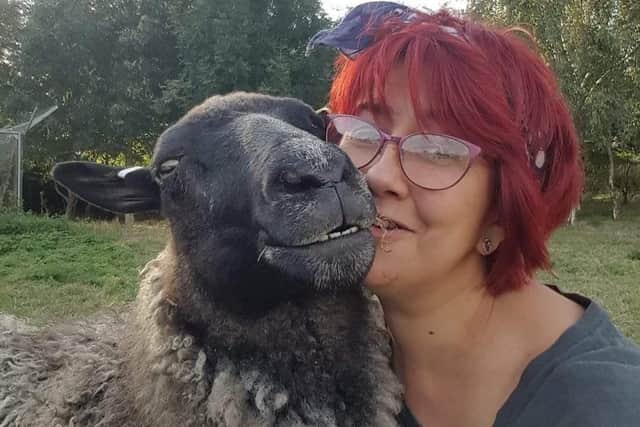 Sheep loving Amanda Gray with Gracie, one of her flock. EMN-220701-154919001