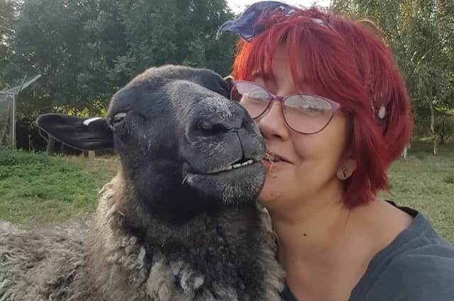 Sheep loving Amanda Gray with Gracie, one of her flock. EMN-220701-154919001