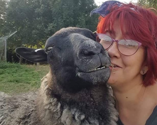 Sheep loving Amanda Gray with Gracie, one of her flock. EMN-220701-154919001