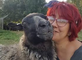Sheep loving Amanda Gray with Gracie, one of her flock. EMN-220701-154919001