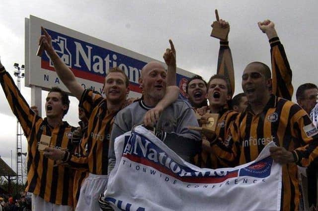 Mark Clifford (right) celebrates the 2002 title win. Photo: Nick Johnson