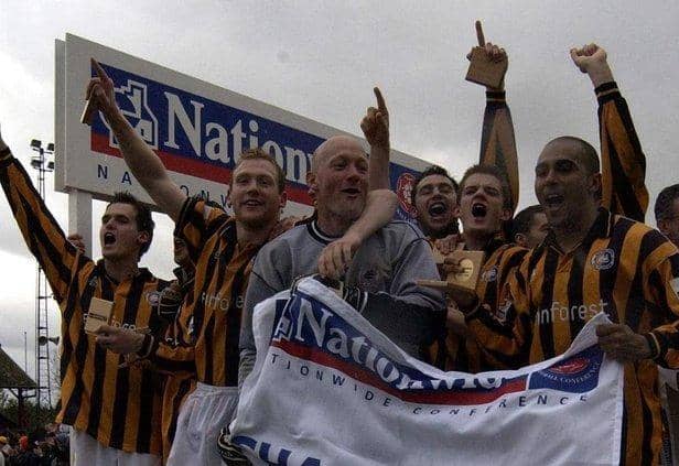 Mark Clifford (right) celebrates the 2002 title win. Photo: Nick Johnson