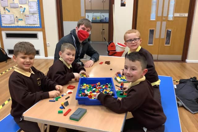 Richmond School teaching assistant Connor Ratcliffe with Year 2 pupils in their After School Club Bubble.
