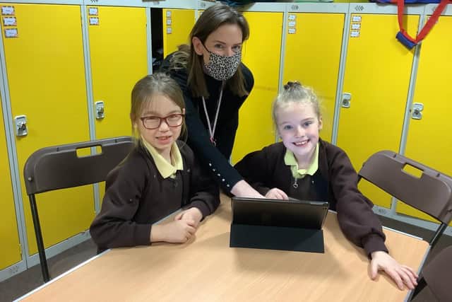 Richmond School teaching assistant Lisa Moore with pupils from Year 3.