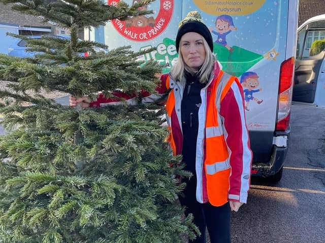 Louise Cotton, Fundraising Officer busy collecting Christmas trees to recycle. EMN-220117-171713001