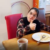 Care home resident Laura gives a thumbs up to her hotel meal. EMN-220119-115440001
