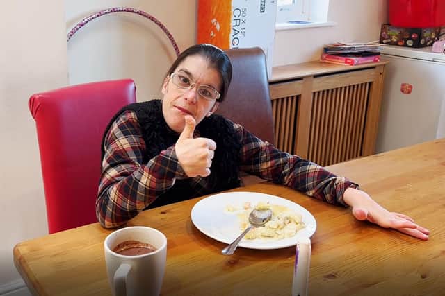 Care home resident Laura gives a thumbs up to her hotel meal. EMN-220119-115440001