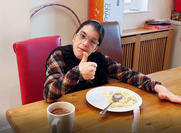 Care home resident Laura gives a thumbs up to her hotel meal. EMN-220119-115440001