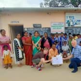 Andrew Cole presenting a cheque for £500 to an orphanage in India. He raised the money with the support of Skegness Lions.
