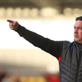 Paul Cox in the dug-out for Kettering at York City earlier this season. Photo: Peter Short