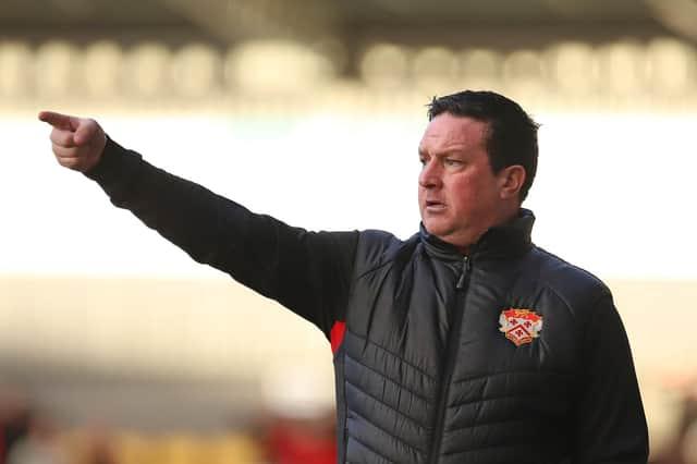 Paul Cox in the dug-out for Kettering at York City earlier this season. Photo: Peter Short